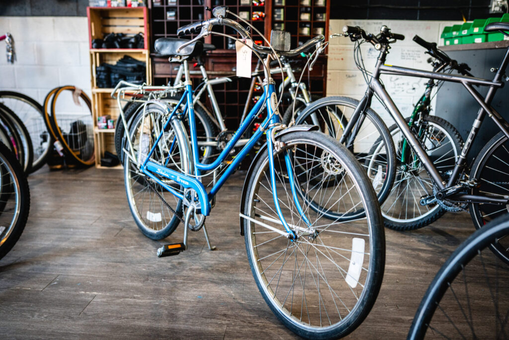 Community_Bike_Shop-57 A blue bike with thin tires and no cross bar.